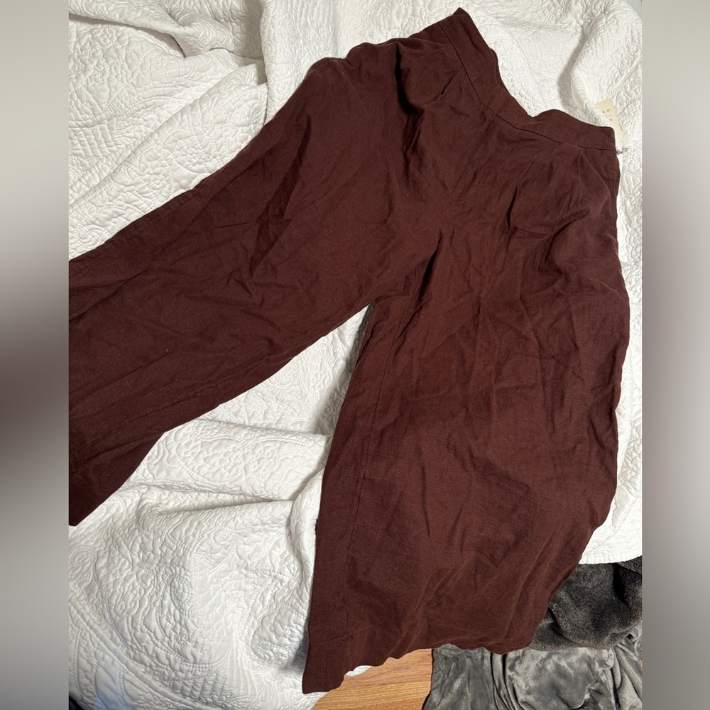 Red - Brown wide leg pants, hovering around ankle height, linen type fabric.